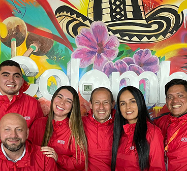 Smiling associates posing for a team photo.