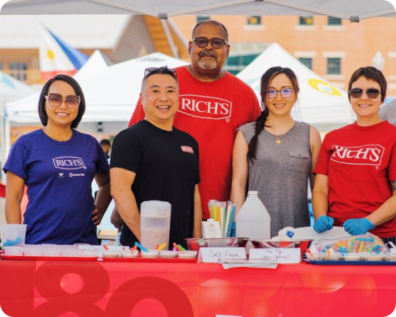 A group of Rich's associates volunteering at a community event.